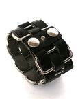 Cholo stainless-steel cuff in vegetable-tanned leather woven through welded solid stainless-steel loops, leather texture detail