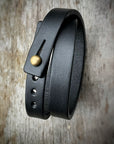 Double wrap cuff in 8oz English bridle leather with stainless-steel hardware, close-up detail