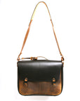 Bacula Messenger bag in full leather construction (structured black leather, pull-up and smooth finish), reinforced with military-grade quick-release buckles and gunmetal rivets at stress points, back view