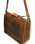 Bacula Messenger bag in full leather construction (structured black leather, pull-up and smooth finish), reinforced with military-grade quick-release buckles and gunmetal rivets at stress points, side view