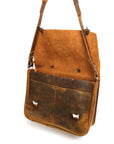 Bacula Messenger bag in full leather construction (structured black leather, pull-up and smooth finish), reinforced with military-grade quick-release buckles and gunmetal rivets at stress points, strap detail