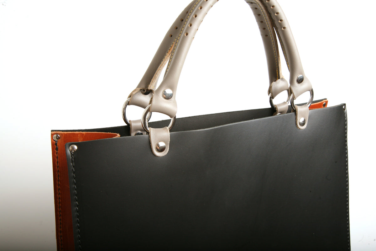 BOX tote bag in leather with solid stainless-steel hardware, strap detail