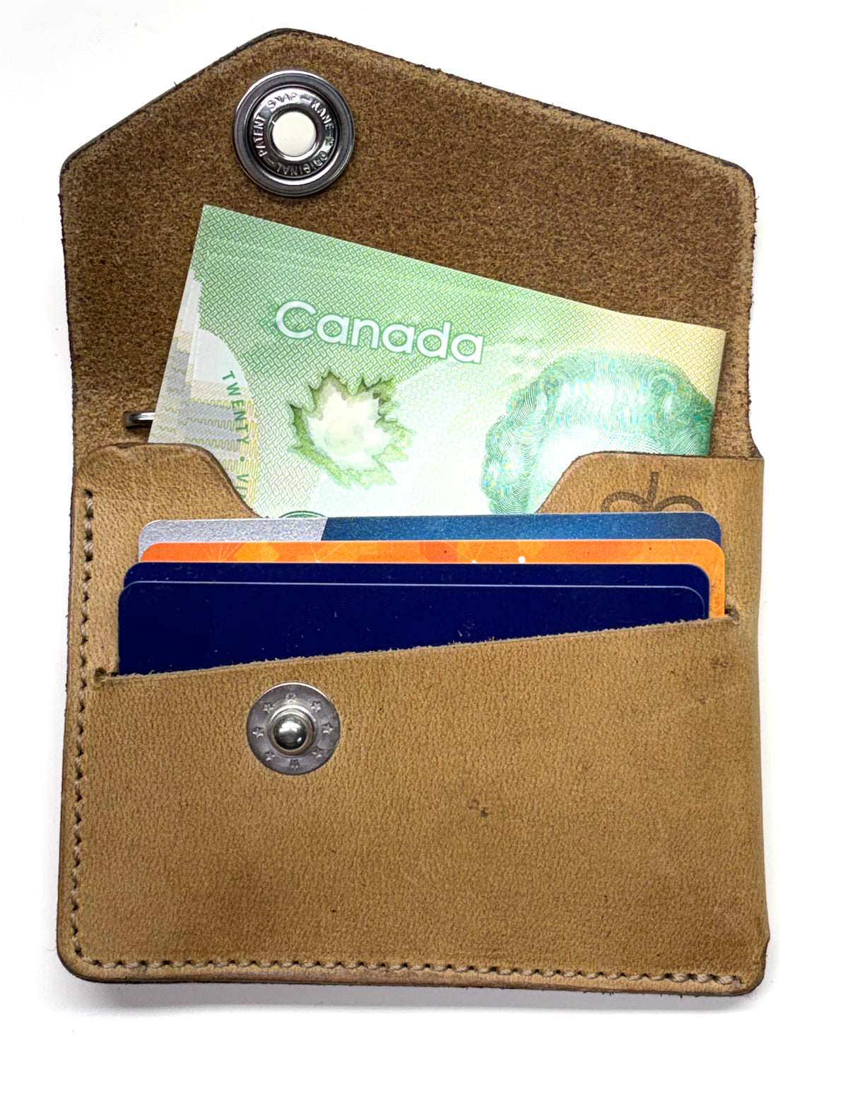 CODA asymmetric wallet in 4oz leather with stainless-steel hardware, close-up detail
