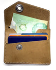 CODA asymmetric wallet in 4oz leather with stainless-steel hardware, close-up detail
