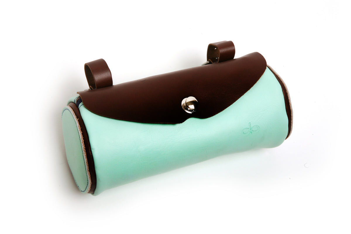 A brown and teal leather cycling handlebar bag with stainless-steel buckles and a wind/rain flap.