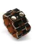 Cholo stainless-steel cuff in vegetable-tanned leather woven through welded solid stainless-steel loops with stainless-steel hardware, alternate angle