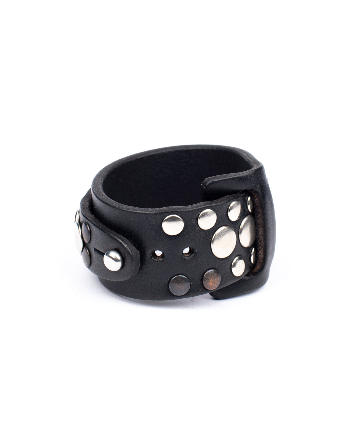Gemini cuff studded in 8-9oz vegetable-tanned leather with stainless-steel hardware, close-up detail