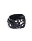 Gemini cuff studded in 8-9oz vegetable-tanned leather with stainless-steel hardware, close-up detail